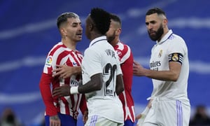 Real Madrid's Vinicius Junior, second left, scuffles with Atletico Madrid's Angel Correa, left, after receiving a red card during a Spanish La Liga soccer match between Real Madrid and Atletico Madrid at the Santiago Bernabeu stadium in Madrid, Spain, Saturday, Feb. 25, 2023. (AP Photo/Manu Fernandez)