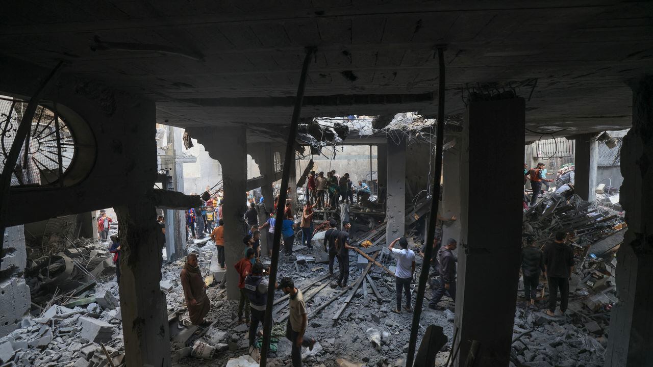 Los palestinos buscan sobrevivientes entre los escombros de un edificio después del bombardeo israelí en Khan Yunis, en el sur de la Franja de Gaza.