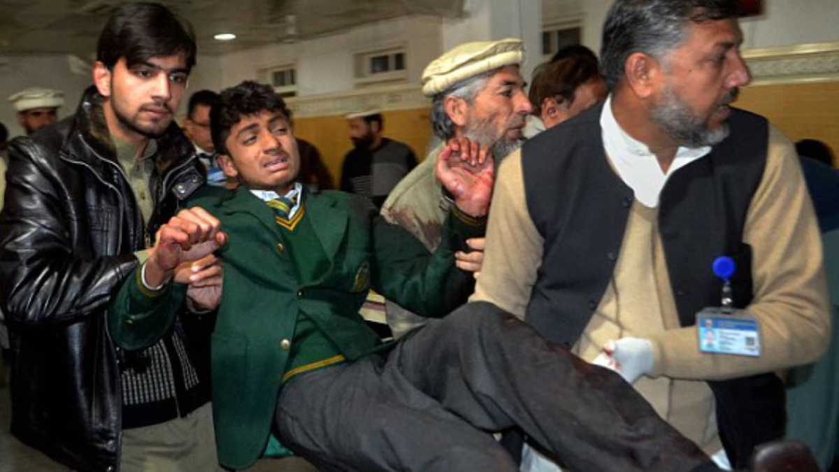 Un joven es auxiliado en la Escuela Pública del Ejército, en Peshawar, Pakistán, luego de un ataque del Talibán en el que 141 personas murieron.