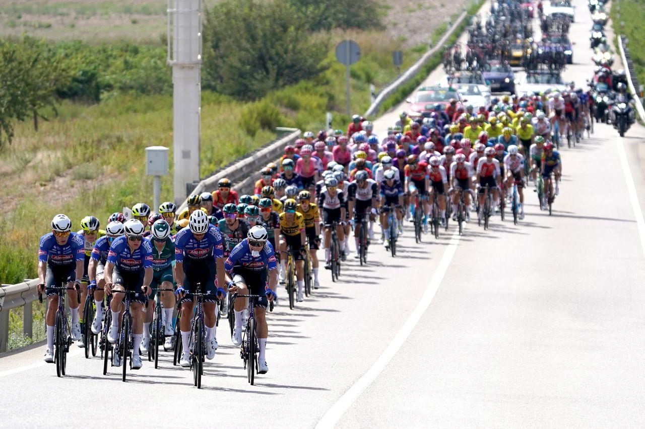 Cyclists ride in a pack in Tauste during the stage 12 of the 2023 La Vuelta cycling tour of Spain, a 150,6 km race between Olvega and Zaragoza, on September 7, 2023. (Photo by CESAR MANSO / AFP)