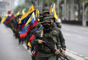 Members of military units and the Bolivarian National Guard participate in a military march and parade within the framework of military exercises called Bolivarian Shield "Supreme Commander Hugo Rafael Chavez Frias 2021," in Caracas on March 5, 2021. - Military units will develop military exercises from March 5 to 7. (Photo by Yuri CORTEZ / AFP)