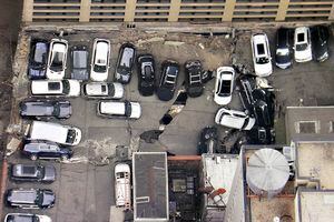 Cars are seen at the partial collapse of a parking garage in the Financial District of New York, Wednesday, April 19, 2023, in New York.  The parking garage collapsed Tuesday in lower Manhattan’s Financial District, killing one worker, injuring five and crushing cars as concrete floors fell on top of each other like a stack of pancakes, officials said.  (Tom Kaminski/WCBS 880 News via AP)