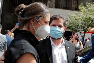 Chilean elected president Gabriel Boric (R) arrives with his partner, Irina Karamanos, at the Election Qualifying Tribunal (Tricel) for his official proclamation as president-elect, in Santiago, on January 10, 2022. - Boric is to take office on March 11, 2022. (Photo by Javier TORRES / AFP)