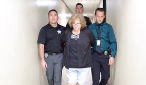 This image taken from video provided by the Marion County Sheriff’s Office shows Susan Lorincz, center, after her arrest in Ocala, Fla., Tuesday, June 6, 2023. Lorincz is accused of fatally shooting her neighbor, Ajike Owens, a Black mother of four. (Marion County Sheriff’s Office via AP)