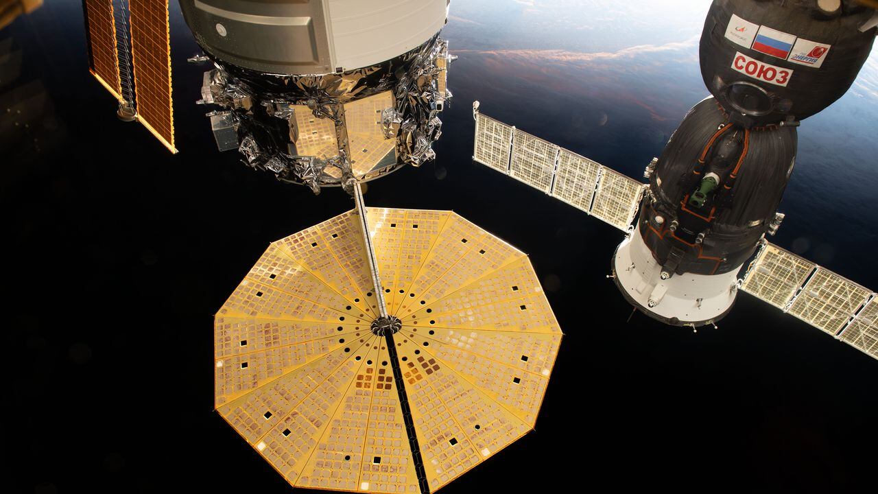 Oct. 18, 2020) --- Two spacecraft are pictured docked to the International Space Station as the complex flew into an orbital sunset above the Tasman Sea in between Australia and New Zealand. At left, with its prominent cymbal-shaped UltraFlex solar arrays is the Northrop Grumman's Cygnus resupply ship. To the right, is the Soyuz MS-17 crew ship that docked to the station on Oct. 14 carrying the Expedition 64 crew.