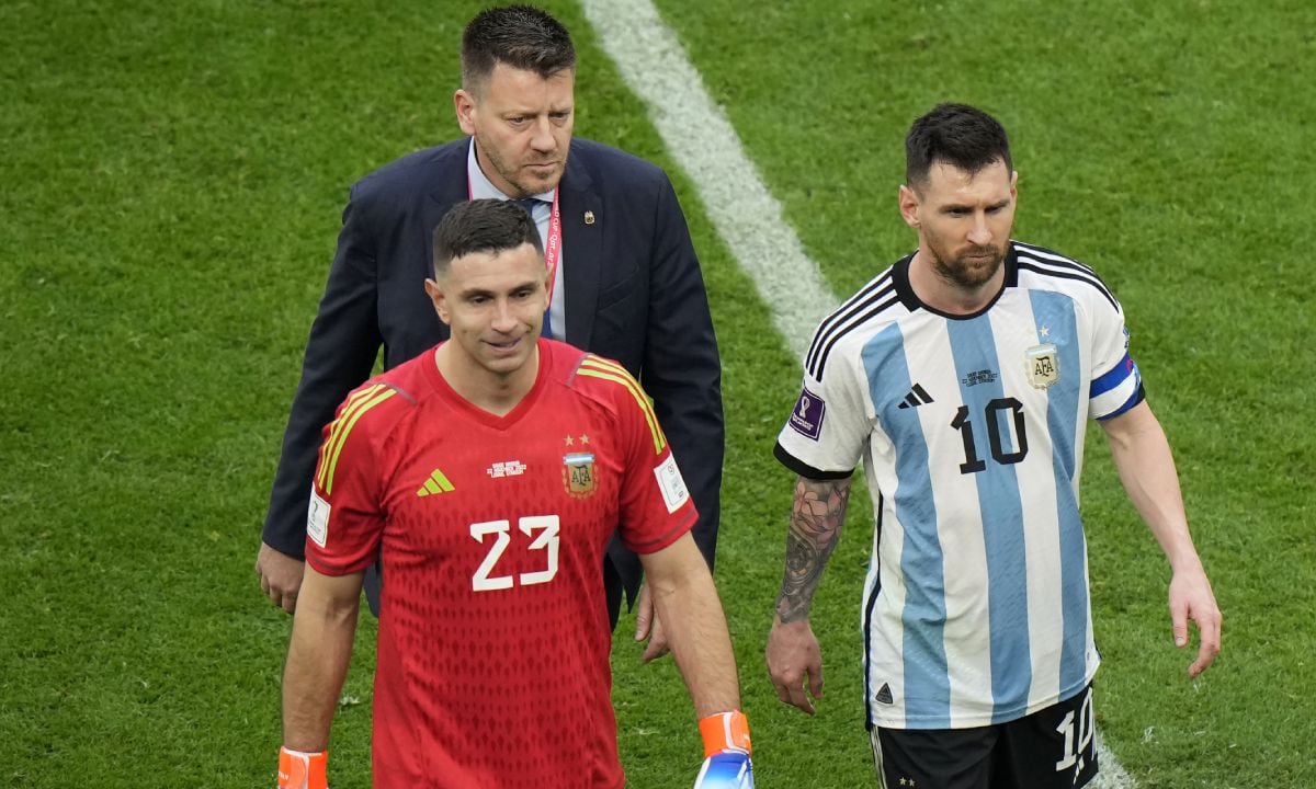 Argentina's Lionel Messi, right, leaves the field with teammate goalkeeper Emiliano Martinez after their loss in the World Cup group C soccer match between Argentina and Saudi Arabia at the Lusail Stadium in Lusail, Qatar, Tuesday, Nov. 22, 2022. (AP/Luca Bruno)