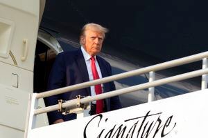 Former President Donald Trump steps off his plane as he arrives at Hartsfield-Jackson Atlanta International Airport, Thursday, Aug. 24, 2023, in Atlanta. (AP Photo/Alex Brandon)
