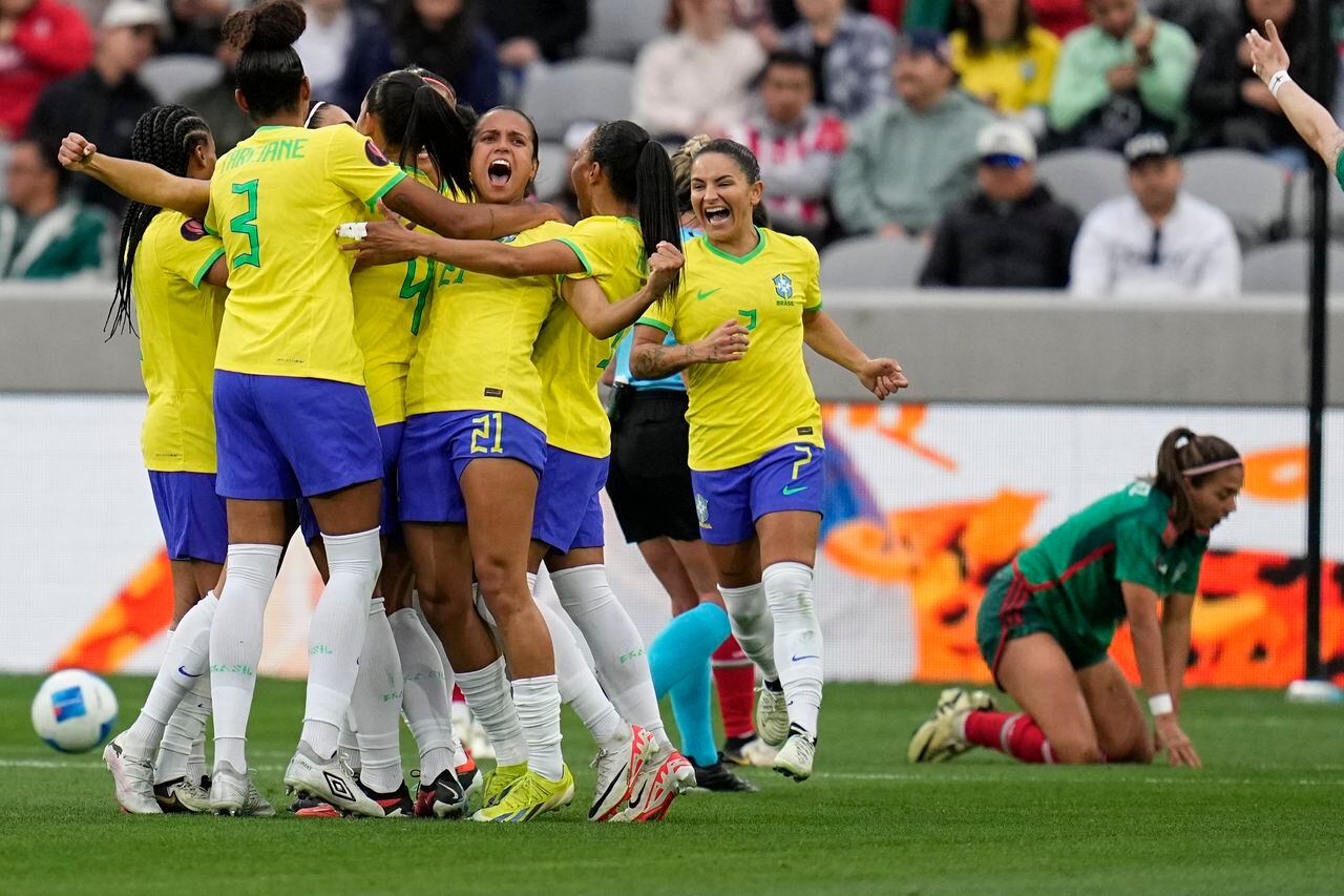 Players from Brazil celebrate a goal from Brazil's Antonia during the first half of a CONCACAF Gold Cup women's soccer tournament semifinal match against Mexico, Wednesday, March 6, 2024, in San Diego. (AP Photo/Gregory Bull)