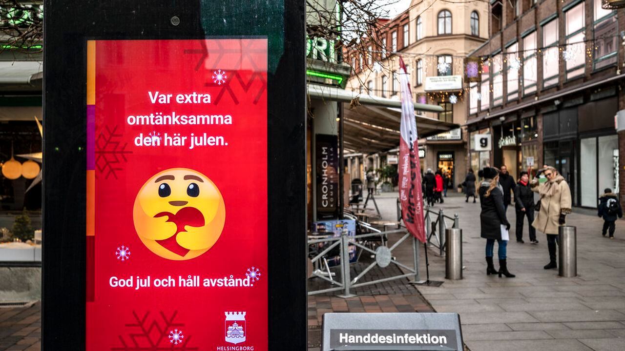 An public information sign wishing Merry Christmas and asking to maintain social distancing is seen in a pedestrian shopping street in Helsingborg, southern Sweden, on Monday Dec. 7, 2020. The last week in November, Helsingborg had more new confirmed Covid-19 cases than in any other city in Sweden, according to official figures. (Johan Nilsson / TT via AP)
