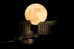 Una luna llena conocida como la "Luna de la Fresa" se eleva detrás del Templo de Poseidón, en Cabo Sounion, cerca de Atenas, Grecia, el 14 de junio de 2022. Foto REUTERS/Alkis Konstantinidis