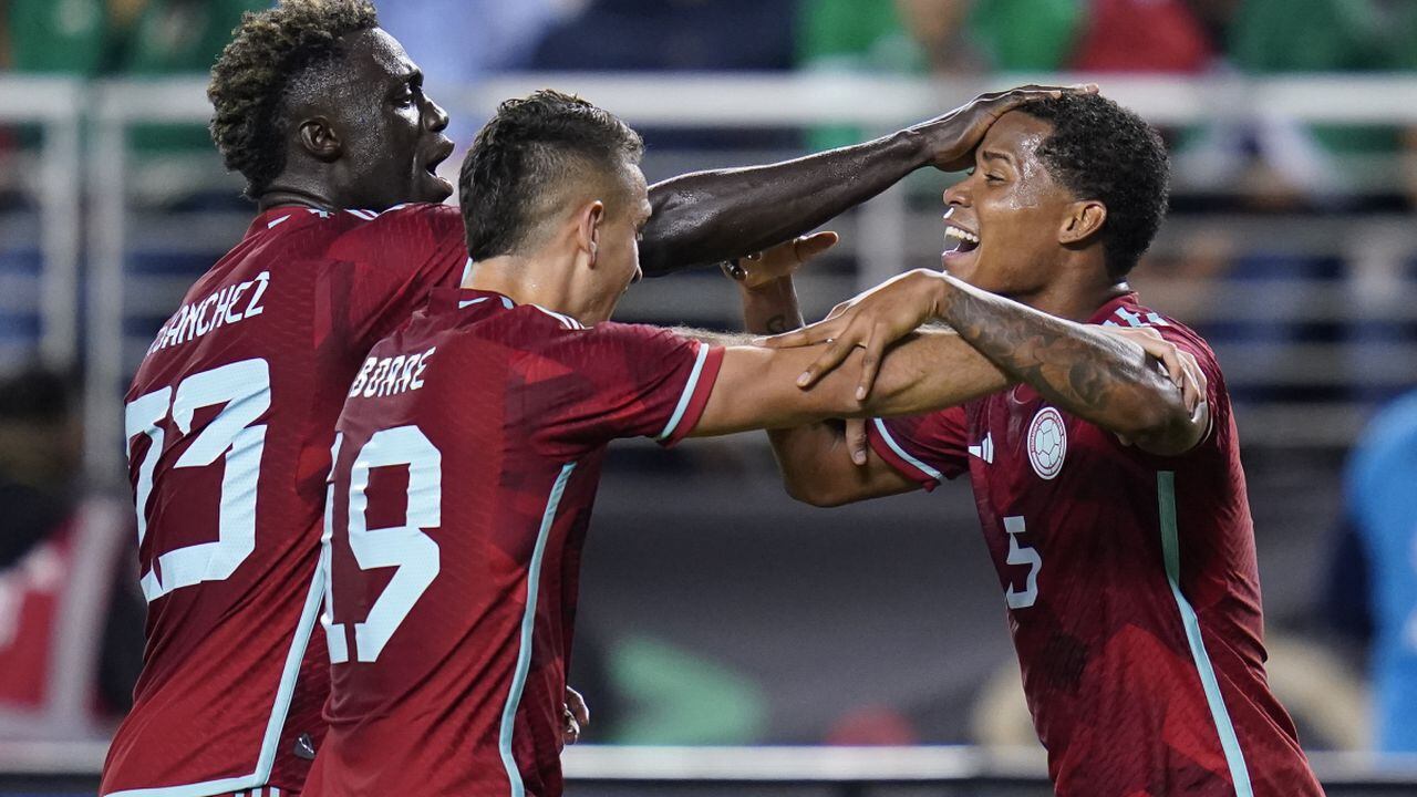 Colombia defender Davinson Sanchez (23) and forward Rafael Borre (19) celebrate with midfielder Wilmar Barrios (5), who scored a goal against Mexico during the second half of an international friendly soccer match in Santa Clara, Calif., Tuesday, Sept. 27, 2022. (AP/Godofredo A. Vásquez)