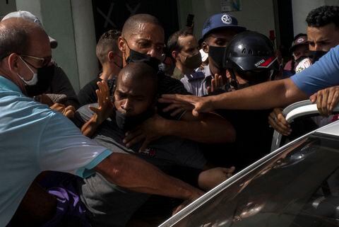 Police detain an anti-government demonstrator during a protest in Havana, Cuba, Sunday July 11, 2021. Hundreds of demonstrators went out to the streets in several cities in Cuba to protest against ongoing food shortages and high prices of foodstuffs, amid the new coronavirus crisis. (AP Photo/Ramon Espinosa)