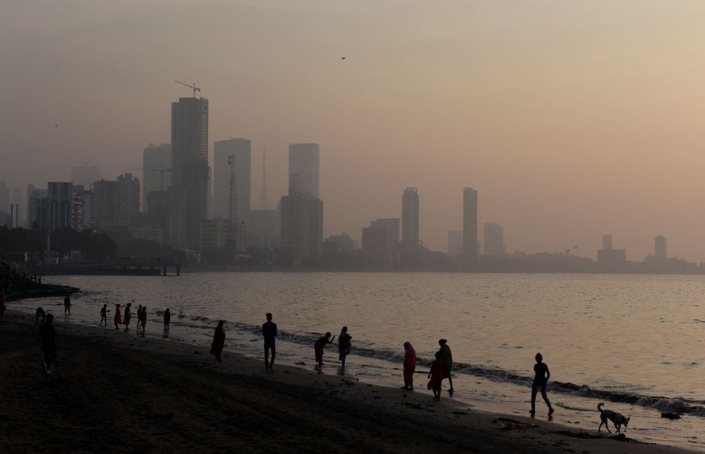 High-rise buildings are visible through dense smog near the sea beach in Mumbai, India, on December 4, 2023. India's financial capital, Mumbai, is witnessing a drop in air quality, according to an Indian media report. (Photo by Indranil Aditya/NurPhoto via Getty Images)