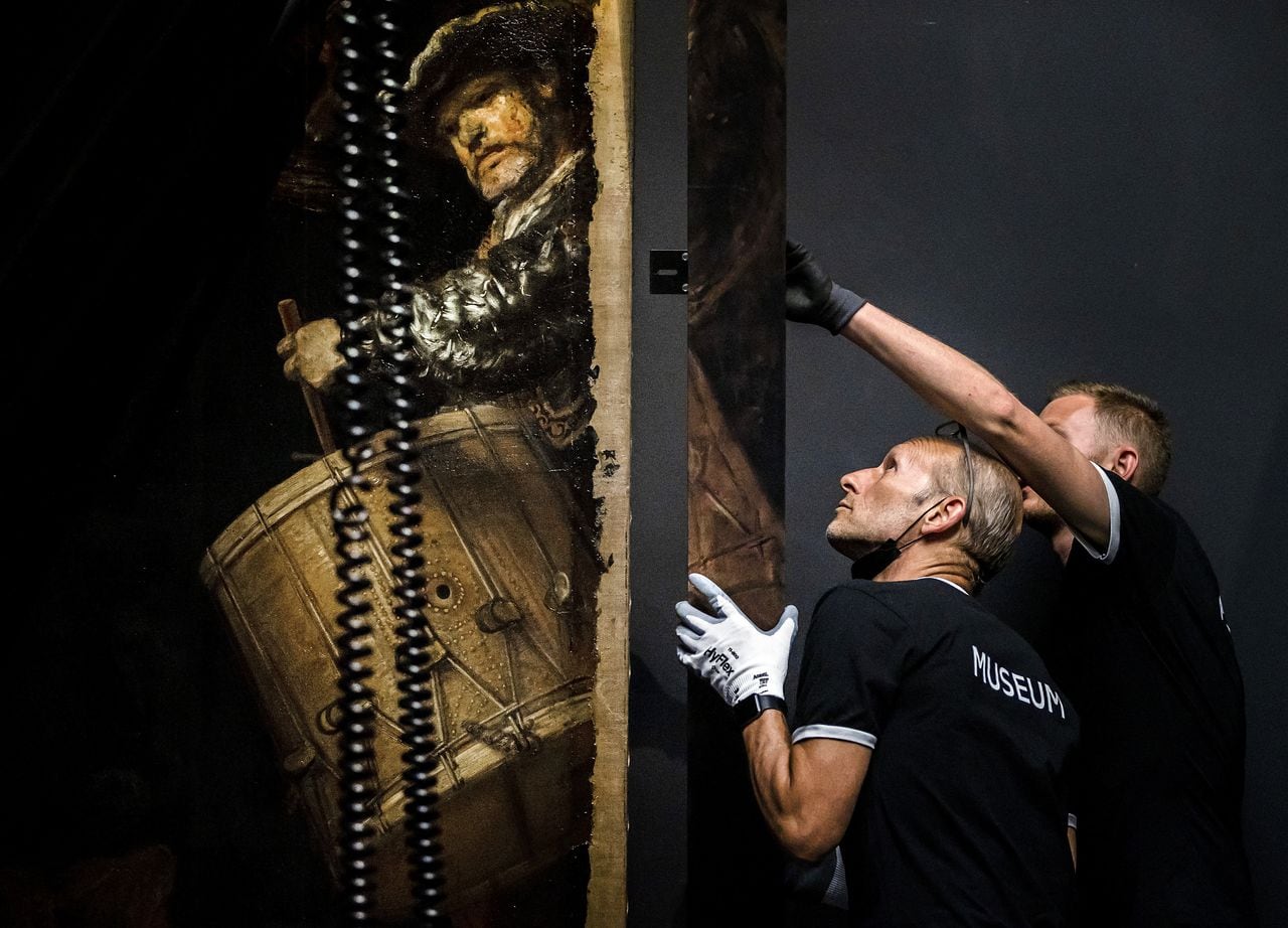 The frame is added to the 1642 'Night Watch' at the Rijksmuseum Museum during 'Operation Night Watch',  the largest ever investigation into the painting by Dutch master Rembrandt in Amsterdam on June 22, 2021. - Using advanced technology the museum is able to determines how best to preserve the masterpiece for future generations. (Photo by Remko de Waal / ANP / AFP) / RESTRICTED TO EDITORIAL USE - MANDATORY MENTION OF THE ARTIST UPON PUBLICATION - TO ILLUSTRATE THE EVENT AS SPECIFIED IN THE CAPTION