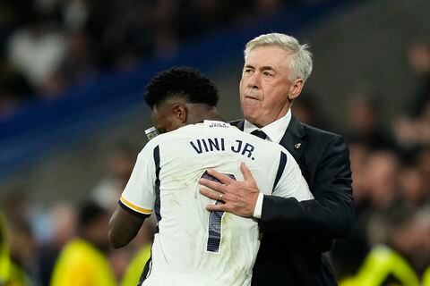 Real Madrid's Vinicius Junior celebrates with Real Madrid's head coach Carlo Ancelotti, right, after scoring his side's third goal during the Spanish La Liga soccer match between Real Madrid and Valencia at the Santiago Bernabeu stadium in Madrid, Spain, Saturday, Nov. 11, 2023. (AP Photo/Jose Breton)