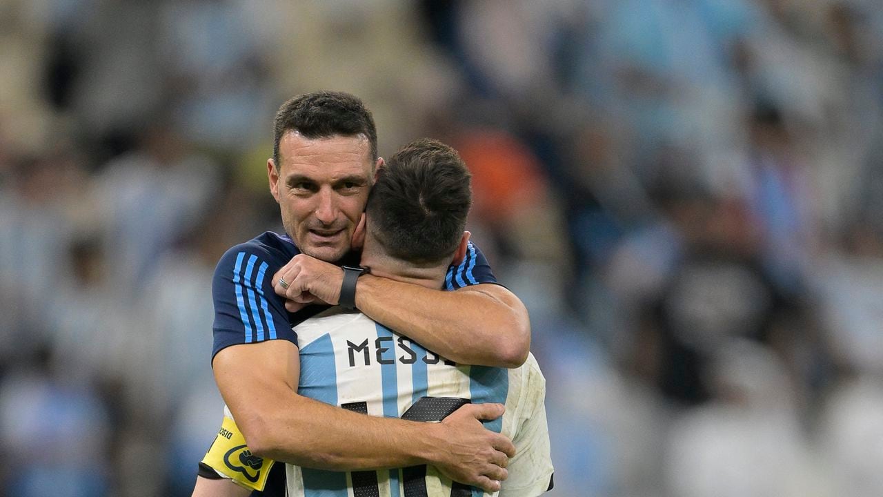 Argentina's forward #10 Lionel Messi is embraced by Argentina's coach #00 Lionel Scaloni after their team's victory in the Qatar 2022 World Cup quarter-final football match between The Netherlands and Argentina at Lusail Stadium, north of Doha on December 9, 2022. (Photo by JUAN MABROMATA / AFP)