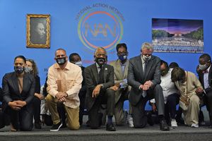 Local leaders and politicians, including Congressman Hakeem Jeffries, third from left, Rev. Al Sharpton, fifth from left, and New York City Mayor Bill de Blasio, seventh from left, kneel for for more than nine minutes to remember the murder of George Floyd in New York, Tuesday, May 25, 2021. Tuesday marks one year since Floyd, who was Black, died after former Minneapolis police officer Derek Chauvin held his knee on Floyd's neck for more than nine minutes as he pleaded for air. Floyd's death sparked worldwide protests and calls for change in policing in the U.S. Chauvin, who is white, was convicted of murder and manslaughter in his death. (AP Photo/Seth Wenig)