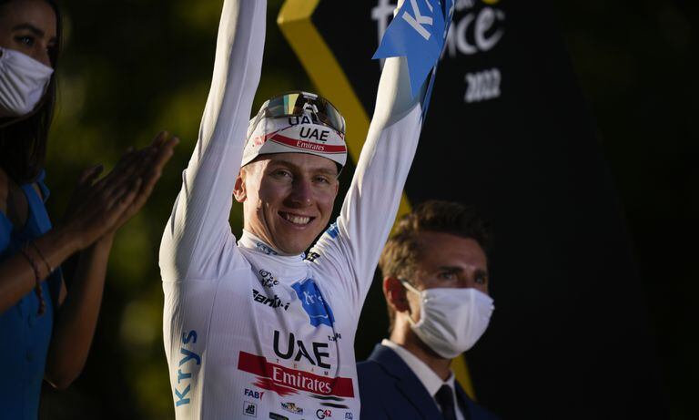Slovenia's Tadej Pogacar, wearing the best young rider's white jersey, celebrates on the podium after the twenty-first stage of the Tour de France cycling race over 116 kilometers (72 miles) with start in Paris la Defense Arena and finish on the Champs Elysees in Paris, France, Sunday, July 24, 2022. (AP/Daniel Cole)