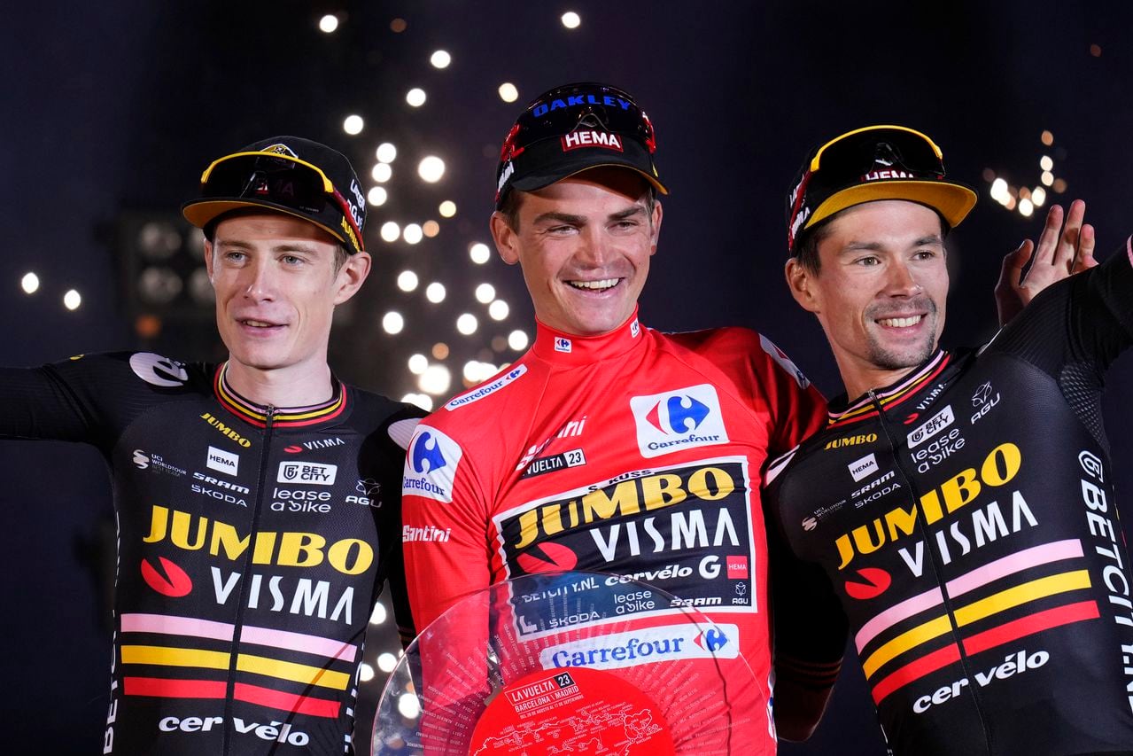 CORRECTS TO ''WINS THE VUELTA'' - The winner Sepp Kuss of Jumbo-Visma, center, celebrates with teammates, second place Jonas Vingegaard, left, and third place Primoz Roglic on the podium after winning the Vuelta cycling race in Madrid, Spain, Sunday, Sept. 17, 2023. (AP Photo/Manu Fernandez)