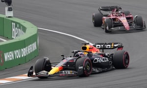 Red Bull driver Max Verstappen of the Netherlands leads Ferrari driver Charles Leclerc of Monaco, right, during the Formula One Dutch Grand Prix auto race, at the Zandvoort racetrack, in Zandvoort, Netherlands, Sunday, Sept. 4, 2022. (AP Photo/Peter Dejong)
