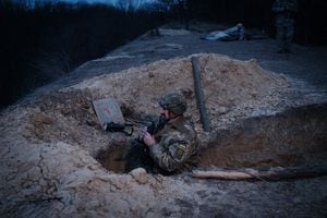 Colonel "Smak", the commander of a Ukrainian volunteer unit, poses in a trench used by the unit to counter threats during air-raid sirens in a suburb of Kyiv on February 28, 2023. - Colonel "Smak" and his Ukrainian volunteer unit of 80 civilian volunteers take turns day and night keeping watch for incoming threats: Iranian-made "Shahed" explosive drones launched by the Russians. Since October, the unit - whose machine gun dates back to the 1920s - has shot down three such drones. A dozen of these units, attached to the territorial defence, cover the sky of the Capital city of Ukraine. (Photo by YASUYOSHI CHIBA / AFP)