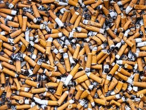 This photograph depicts countless cigarette butts in a public ashtray. The photograph was taken in the city of Courbevoie, in the department of Hauts-de-Seine, France.