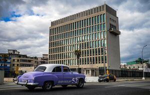 Un viejo automóvil estadounidense pasa frente a la embajada de EE. UU. en La Habana el 3 de mayo de 2022, cuando el consulado reanudó la emisión de algunos servicios de visas de inmigrantes que han estado suspendidos desde 2017 luego de supuestos "ataques sónicos".