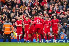 Liverpool players celebrate after Liverpool's Mohamed Salah, centre, scored his side's opening goal during the English Premier League soccer match between Liverpool and Everton, at Anfield in Liverpool, England, Saturday, Oct. 21, 2023. (AP Photo/Jon Super)