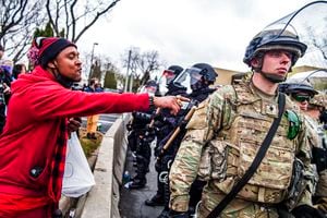 A protester points out to a National Guardsman while protesting the fatal shooting by police of Daunte Wright at a rally at the Brooklyn Center Police Department in Brooklyn Center, Minn., Monday, April 12, 2021. (Richard Tsong-Taatarii/Star Tribune via AP)
