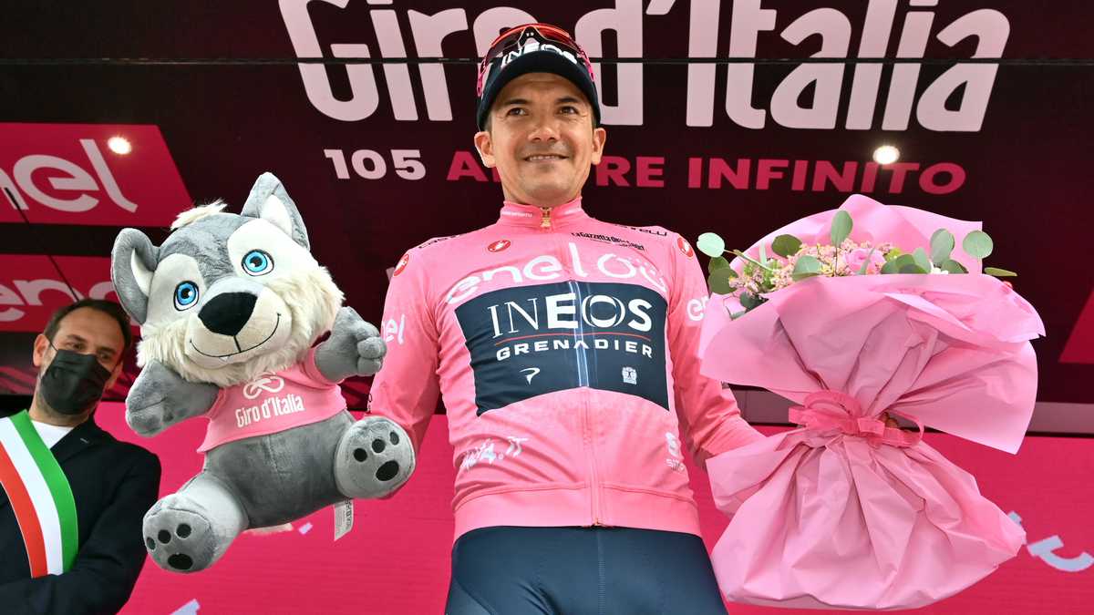 Ecuador's Richard Carapaz wears the pink jersey of the overall leader as he celebrates on podium after completing the 18th stage of the Giro D'Italia cycling race, from Borgo Valsugana to Treviso, Italy, Thursday, May 26, 2022. (Massimo Paolone/LaPresse via AP)