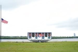 Members of the SpaceX Crew 2, from left, Thomas Pesquet, of the European Space Agency, NASA astronauts Megan McArthur, Shane Kimbrough, and Akihiko Hoshide, of the Japan Aerospace Exploration Agency, are shown on a video screen as the SpaceX Falcon 9 with the crew Dragon capsule sits on Launch Complex 39A Wednesday, April 21, 2021, at the Kennedy Space Center in Cape Canaveral, Fla. Four astronauts will fly on the SpaceX Crew-2 mission to the International Space Station scheduled for launch on April 23, 2021. (AP Photo/Brynn Anderson)