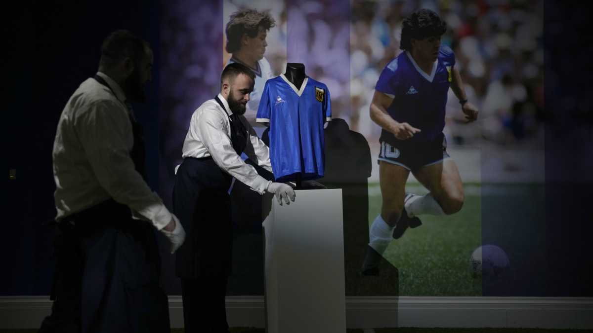 The Argentina football shirt worn by Diego Maradona in the 1986 Mexico World Cup quarterfinal soccer match between Argentina and England, is displayed for photographs at Sotheby's auction house, in London, Wednesday, April 20, 2022. The shirt which is for sale in an online auction running from April 20 to May 4, is estimated to fetch 4 million pounds (US $5.2 million, 4.8 million euro) and was worn by Maradona in the match in which he scored the "Hand of God" and the "Goal of the Century". (AP/Matt Dunham)