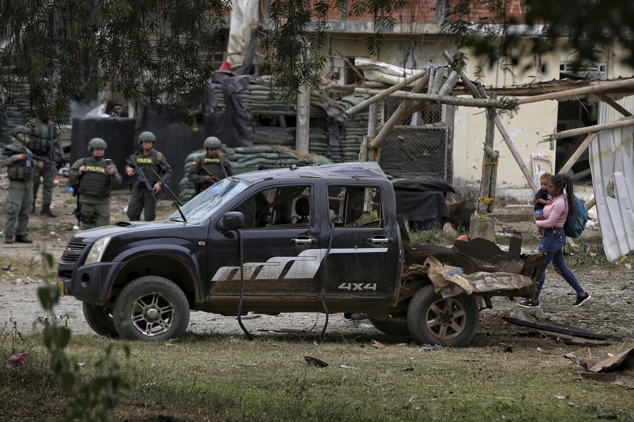 Police stand guard before a damaged police station after a car bomb exploded, in Timba, Cauca, Colombia, Sunday, Aug. 13, 2023. According to police, the car bomb killed one police officer. (AP Photo/Andres Quintero)