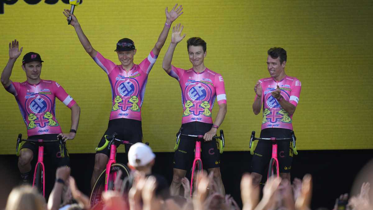 Magnus Cort Nielsen of Denmark, second left, Neilson Powless of the U.S., second right, and Rigoberto Uran of Colombia, right, of the EF Education EasyPost team greet fans during the team presentation ahead of the Tour de France cycling race in Copenhagen, Denmark, Wednesday, June 29, 2022. The race starts Friday, July 1, the first stage is an individual time trial over 13.2 kilometers (8.2 miles) with start and finish in Copenhagen. (AP Photo/Daniel Cole)