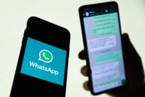 WhatsApp logo displayed on a phone screen and conversation on the WhatsApp displayed on a phone screen in the background are seen in this illustration photo taken in Krakow, Poland on August 27, 2021. (Photo Illustration by Jakub Porzycki/NurPhoto via Getty Images)