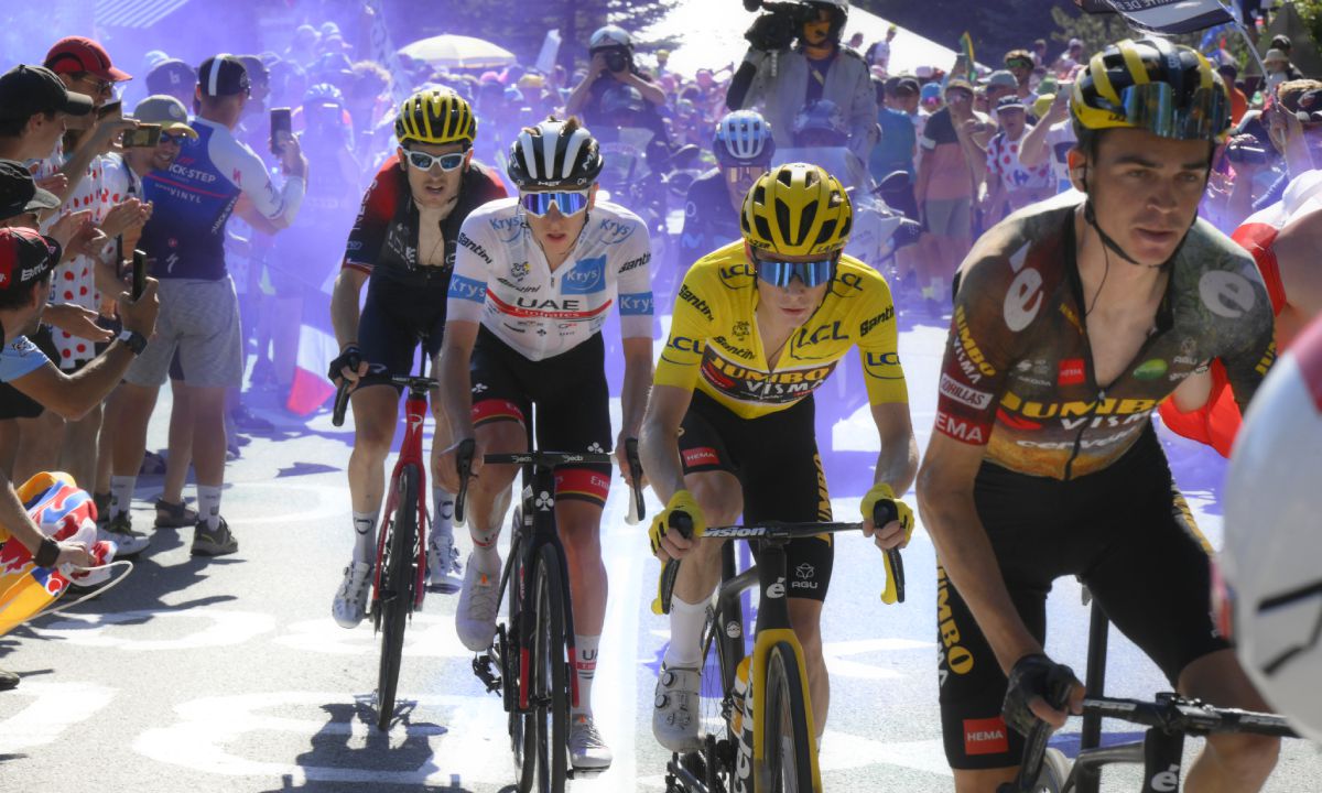 Sepp Kuss of the U.S., Denmark's Jonas Vingegaard, wearing the overall leader's yellow jersey, Slovenia's Tadej Pogacar, wearing the best young rider's white jersey, and Britain's Geraint Thomas, from right, climb Alpe d'Huez during the twelfth stage of the Tour de France cycling race over 165.5 kilometers (102.8 miles) with start in Briancon and finish in Alpe d'Huez, France, Thursday, July 14, 2022. (AP/Bernard Papon/Pool )