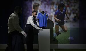 The Argentina football shirt worn by Diego Maradona in the 1986 Mexico World Cup quarterfinal soccer match between Argentina and England, is displayed for photographs at Sotheby's auction house, in London, Wednesday, April 20, 2022. The shirt which is for sale in an online auction running from April 20 to May 4, is estimated to fetch 4 million pounds (US $5.2 million, 4.8 million euro) and was worn by Maradona in the match in which he scored the "Hand of God" and the "Goal of the Century". (AP Photo/Matt Dunham)