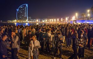 People crowded on the beach in Barcelona, Spain, Sunday, May 9, 2021. Barcelona residents were euphoric as the clock stroke midnight, ending a six-month-long national state of emergency and consequently, the local curfew. Spain is relaxing overall measures to contain the coronavirus this weekend, allowing residents to travel across regions, but some regional chiefs are complaining that a patchwork of approaches will replace the six-month-long national state of emergency that ends at midnight on Saturday. (AP Photo/Emilio Morenatti)