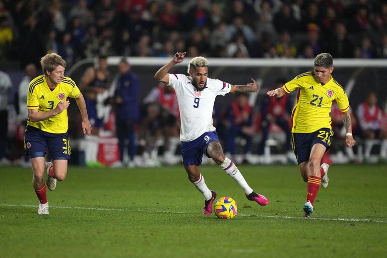 Jan 28, 2023; Carson, California, USA; USMNT forward Jesus Ferreira (9) and Columbia defender Andres Linas (4) and midfielder Jorman Campuzano (21) pursue the ball in the second half at Dignity Health Sports Park. The teams played to a 0-0 tie. Mandatory Credit: Kirby Lee-USA TODAY Sports
