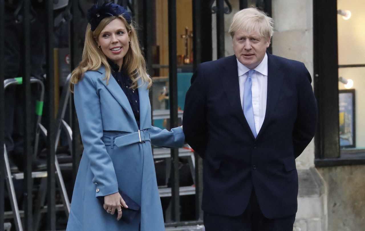 (FILES) In this file photo taken on March 09, 2020 Britain's Prime Minister Boris Johnson (R) with his partner Carrie Symonds leave after attending the annual Commonwealth Service at Westminster Abbey in London on March 09, 2020. - British Prime Minister Boris Johnson and his fiancee Carrie Symonds have set a wedding date for 2022 after delaying plans due to the pandemic, The Sun tabloid reported on May 24, 2021. (Photo by Tolga AKMEN / AFP)