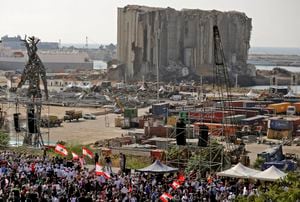 Demonstrators gather near the damaged grain silos outside the port of Lebanon's capital Beirut on August 4, 2021, on the first anniversary of the blast that ravaged the port and the city. - Hundreds of Lebanese marched on August 4 to mark a year since a cataclysmic explosion ravaged Beirut, protesting impunity over the country's worst peacetime disaster at a time when its economy was already in tatters. (Photo by JOSEPH EID / AFP)