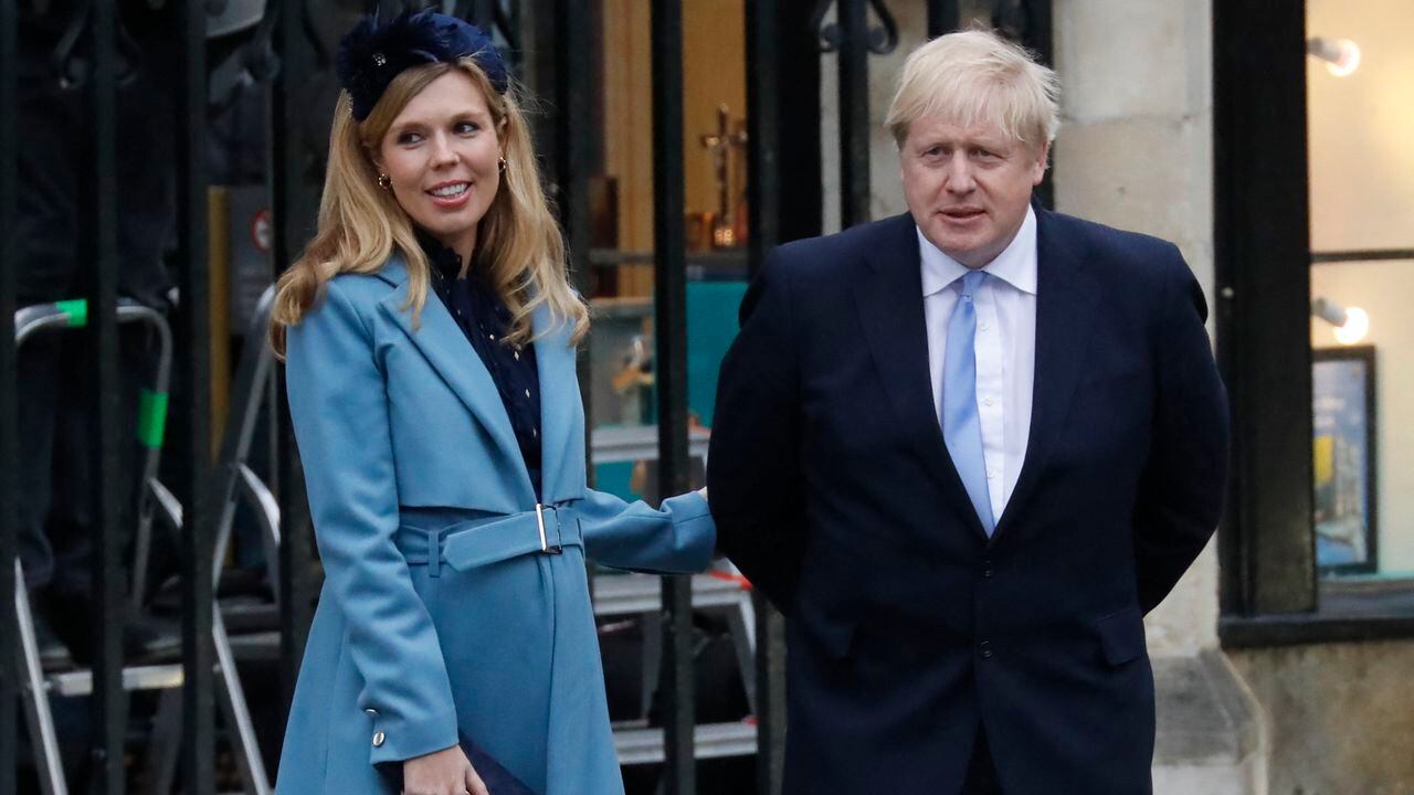 (FILES) In this file photo taken on March 09, 2020 Britain's Prime Minister Boris Johnson (R) with his partner Carrie Symonds leave after attending the annual Commonwealth Service at Westminster Abbey in London on March 09, 2020. - British Prime Minister Boris Johnson and his fiancee Carrie Symonds have set a wedding date for 2022 after delaying plans due to the pandemic, The Sun tabloid reported on May 24, 2021. (Photo by Tolga AKMEN / AFP)