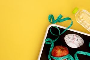 Weight scale and measure tape with fresh apple , Healthy diet for weight loss control concept