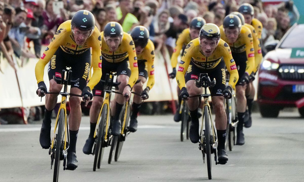 Jumbo Visma team riders with new overall leader Robert Gesink of The Netherlands, left, and Slovenia's Primoz Roglic, right, cross the finish line during the first stage of the Vuelta cycling race, a team time trial over 23.3 kilometers (14.5 miles) with start and finish in, Utrecht, Netherlands, Friday, Aug. 19, 2022. (AP/Peter Dejong)
