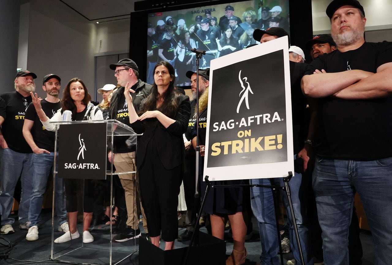 LOS ANGELES, CALIFORNIA - JULY 13: SAG-AFTRA President Fran Drescher (3rd L) speaks at a press conference announcing their strike against Hollywood studios on July 13, 2023 in Los Angeles, California. Members of SAG-AFTRA, Hollywood�s largest union which represents actors and other media professionals, will join striking WGA (Writers Guild of America) workers at midnight in the first joint walkout against the studios since 1960. The strike could shut down Hollywood productions completely with writers in the third month of their strike against the Hollywood studios.   Mario Tama/Getty Images/AFP (Photo by MARIO TAMA / GETTY IMAGES NORTH AMERICA / Getty Images via AFP)