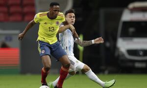 Argentina's Lautaro Martinez, right, and Colombia's Yerry Mina battle for the ball during a Copa America semifinal soccer match at the National stadium in Brasilia, Brazil, Tuesday, July 6, 2021. (AP Photo/Eraldo Peres)