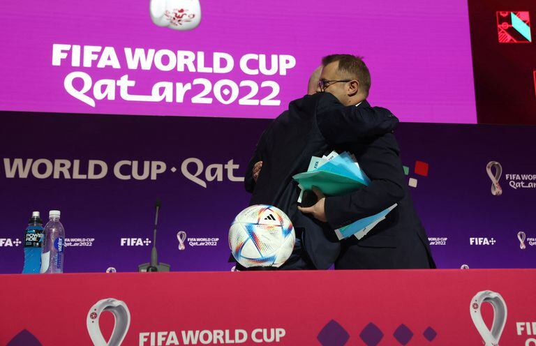 Soccer Football - FIFA World Cup Qatar 2022 - FIFA President Press Conference - Main Media Center, Doha, Qatar - November 19, 2022 FIFA president Gianni Infantino embraces FIFA Director of Media Relations Bryan Swanson after he made an announcement during a press conference REUTERS/Matthew Childs