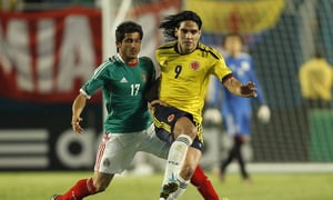 MIAMI GARDENS, FL - FEBRUARY 29: Radamel Falcao Garcia #9 of Colombia and Damian Alvarez #17 of Mexico battle for control of the ball on February 29, 2012 during an International friendly at Sun Life Stadium in Miami Gardens, Florida. Colombia defeated Mexico 2-0. (Photo by Joel Auerbach/Getty Images)