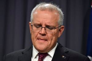 Australian Prime Minister Scott Morrison reacts while speaking during a press conference at Parliament House in Canberra, Tuesday, March 23, 2021. Morrison said he was shocked and disgusted by the latest sex scandal to rock his government and vowed to do more to attract women into politics. He said a lawmaker’s staff member at the center of the latest allegations of sexual misconduct had been terminated over “disgusting and sickening” behavior. (Mick Tsikas/AAP Image via AP)