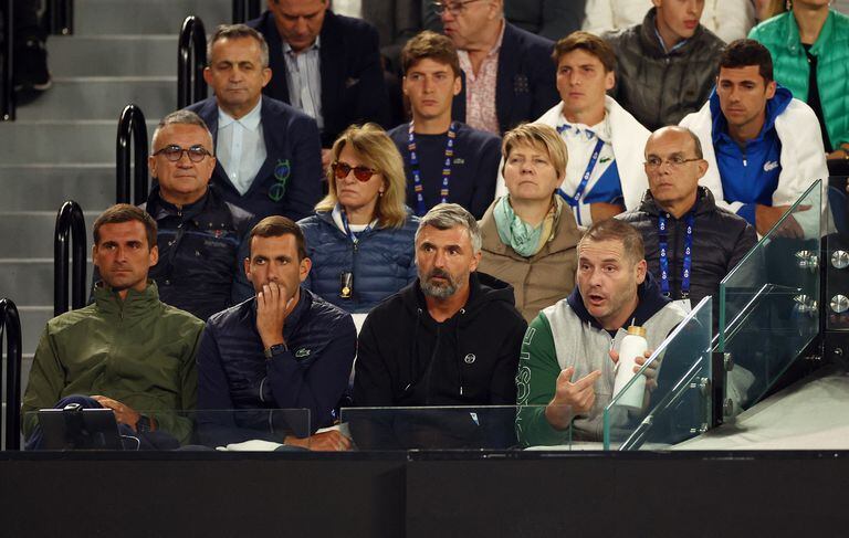 Tennis - Australian Open - Melbourne Park, Melbourne, Australia - January 19, 2023 Serbia's Novak Djokovic parents, Srdjan and Dijana Djokovic, his managers Elena Cappellaro and Edoardo Artaldi and his brother Djordje Djokovic are pictured in the stands as his Serbia's Novak Djokovic's coach Goran Ivanisevic's assistant hold a bottle of water during the second round match against France's Enzo Couacaud REUTERS/Carl Recine